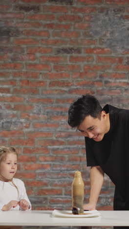emotional surprised little girl with positive asian teacher do magical scientific experiment with soda drink and pop candy at fun chemistry lesson slow motion
