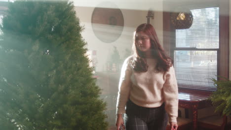 person trimming and preparing a christmas tree