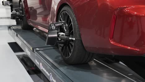 wheel balancing and alignment equipment on a car wheel at a repair shop, luxury car wheel balancing and alignment