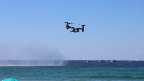 helicopter flying over ocean near naval ship