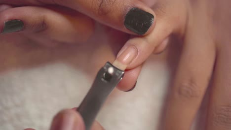 process of clipping fingernails during a manicure, cut with clippers