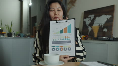 woman reading documents in a cafe