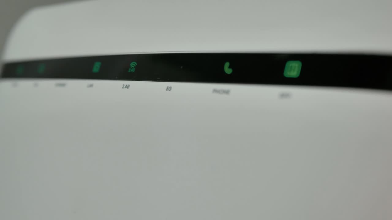 Upgraded: Wi-Fi Router, Home Network, Wireless Technology. A Wi-Fi Internet router with three computers connected to a local network flashes lights in a dark room.