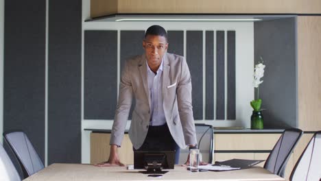 african american businessman talking on video call in conference room in modern office