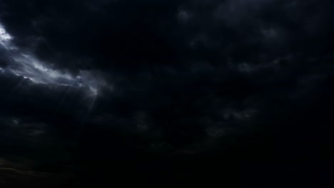 thunderstorm clouds at night with light rays from top. 4k timelapse loop.