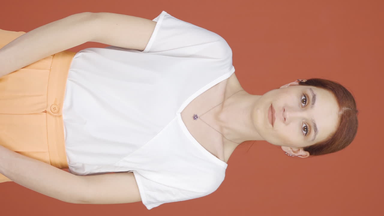 video vertical de una mujer mirando a la cámara con una expresión negativa.