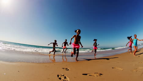 children running on a sunny beach