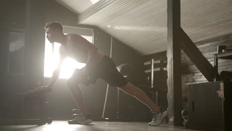man doing dumbbell workout in the gym