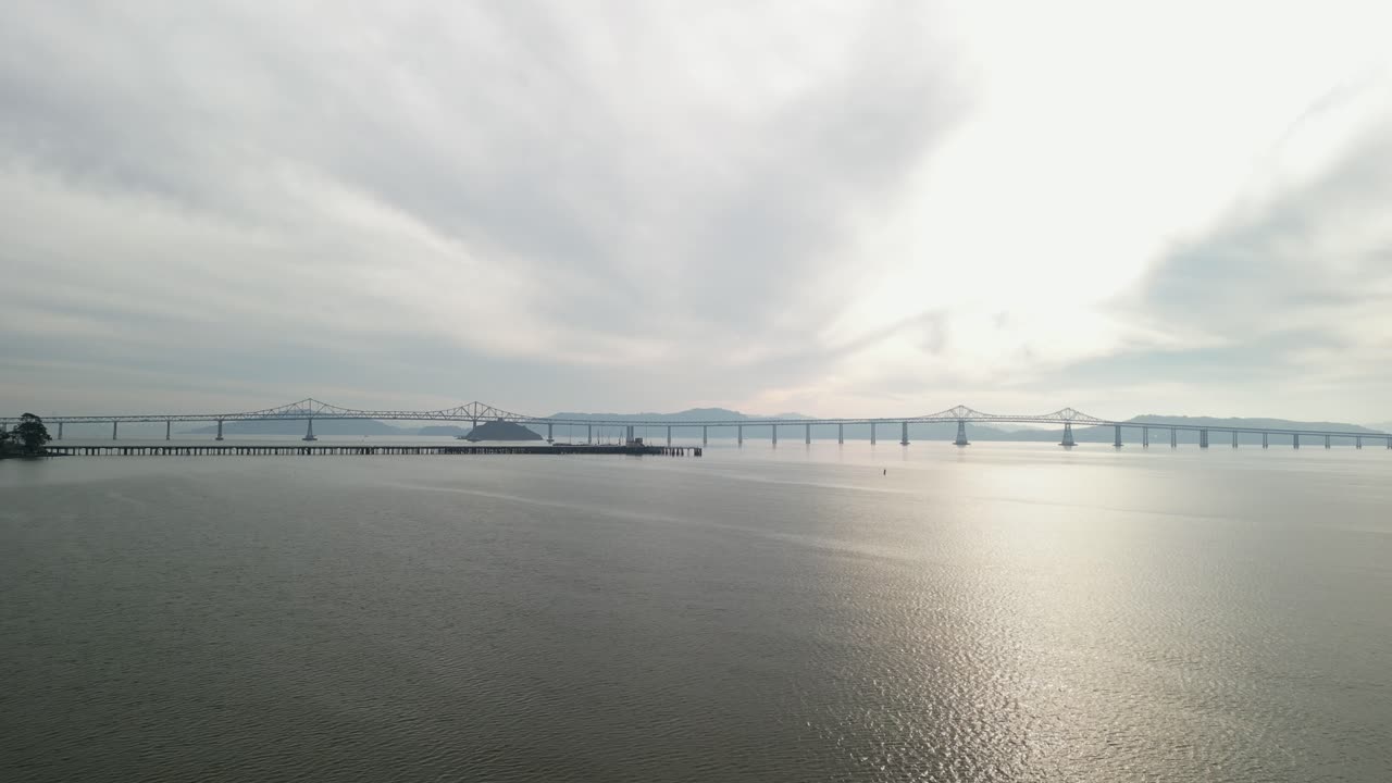 The Richmond–San Rafael Bridge stretches into the distance, with Point Molate Beach and hills in the background.