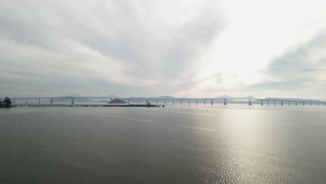 the richmond–san rafael bridge stretches into the distance, with point molate beach and hills in the background.