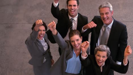 happy business team raising fists