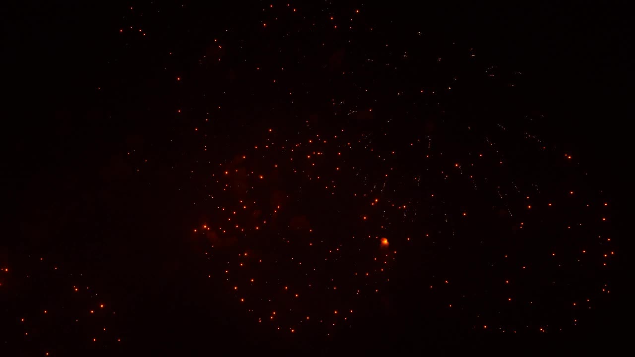 Real fireworks on deep black background sky, beautiful colorful fireworks shiny display at night, real time 4k footage.