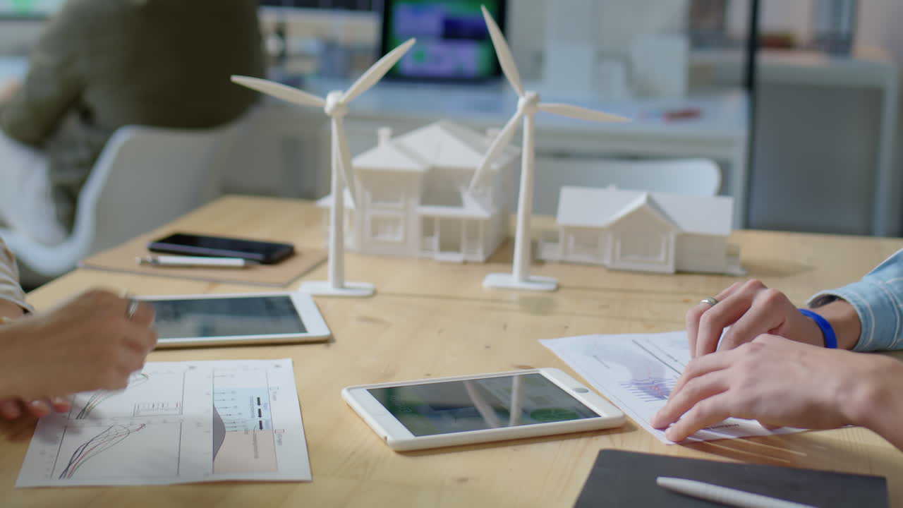 Colleagues Shaking Hands and Discussing Renewable Energy Project