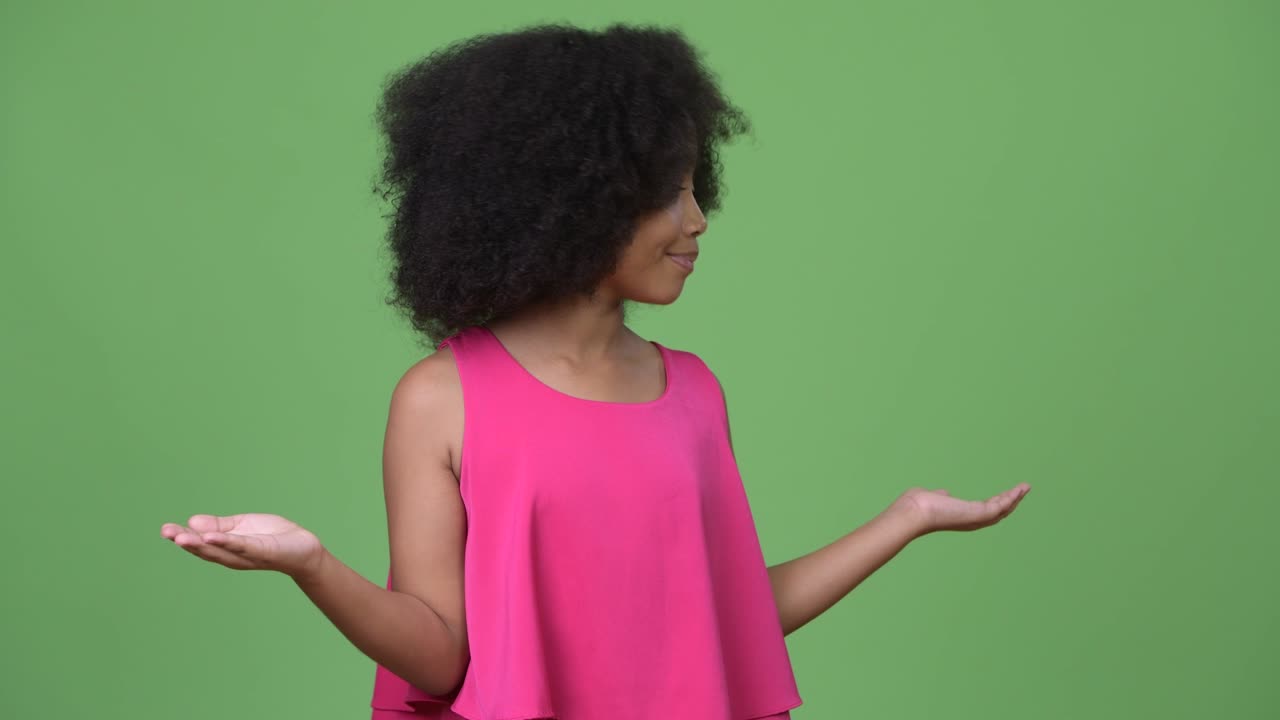 Young cute African girl with Afro hair choosing between left and right