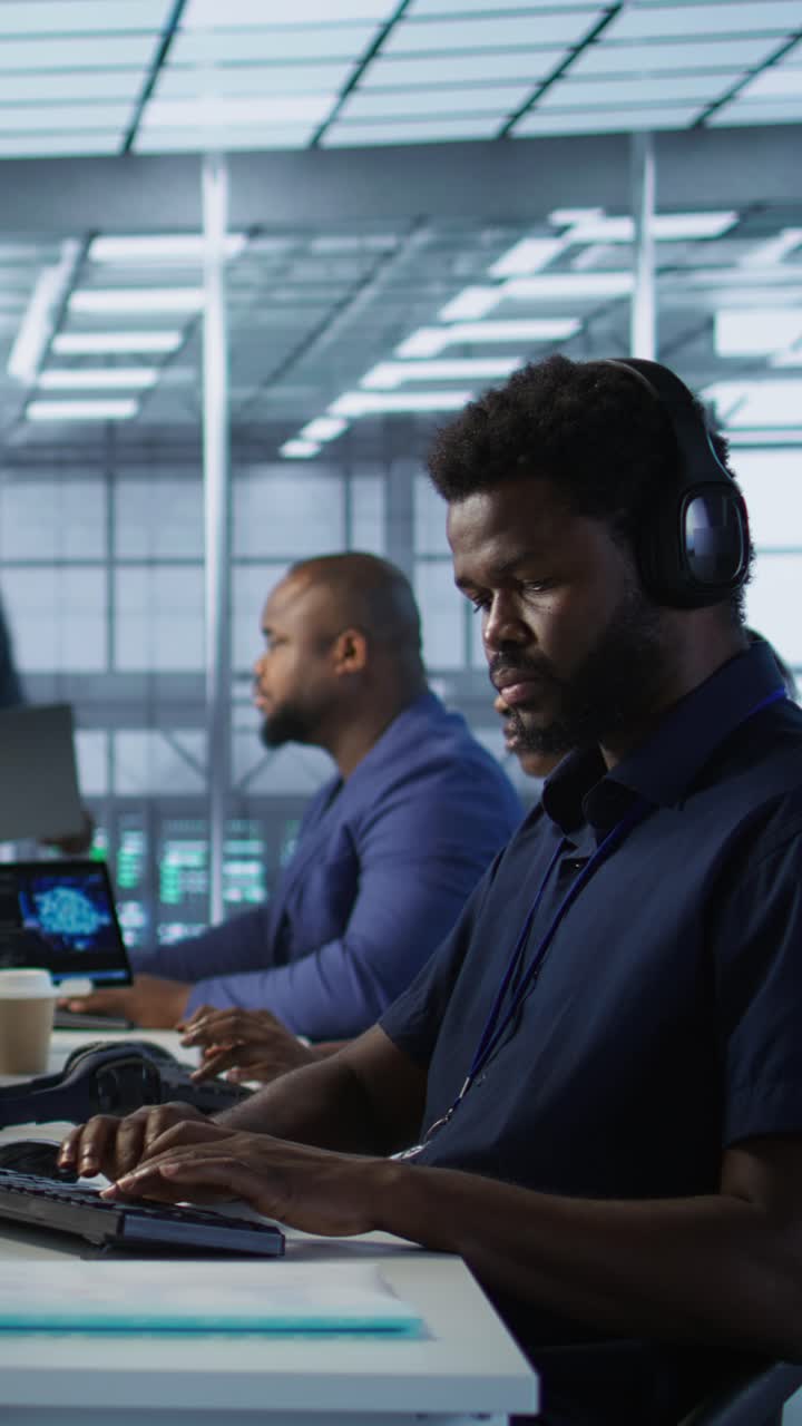 Vertical video Data center admin typing on keyboard, maintaining company infrastructure