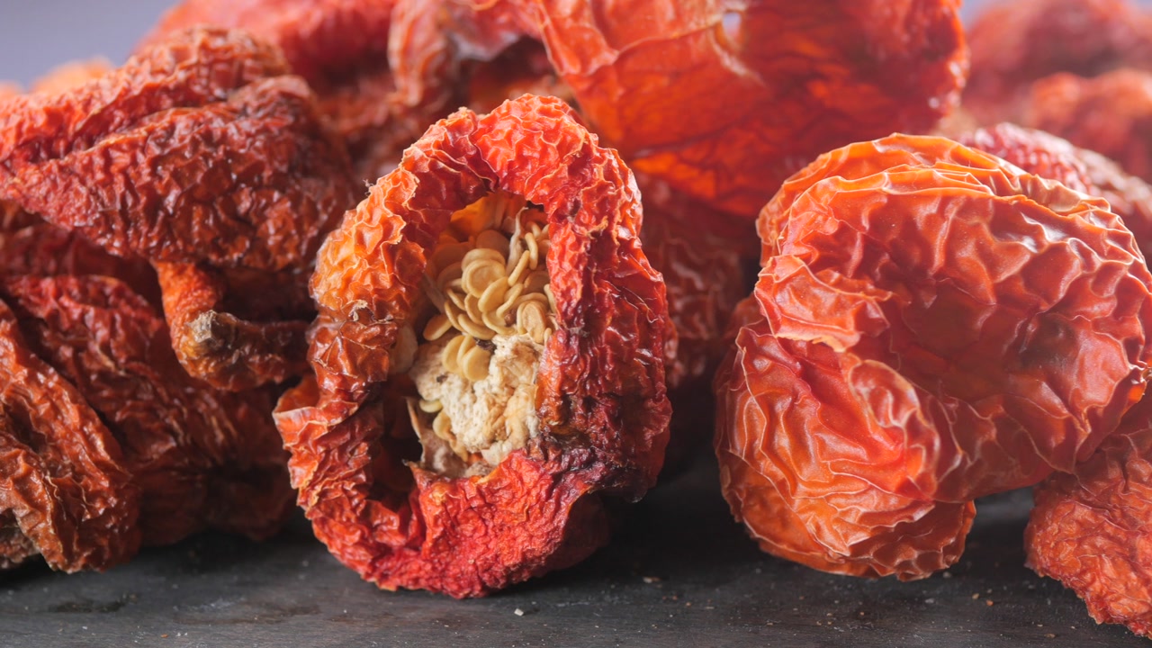Rotating Close-up of Dried Red Chili Peppers and Seeds