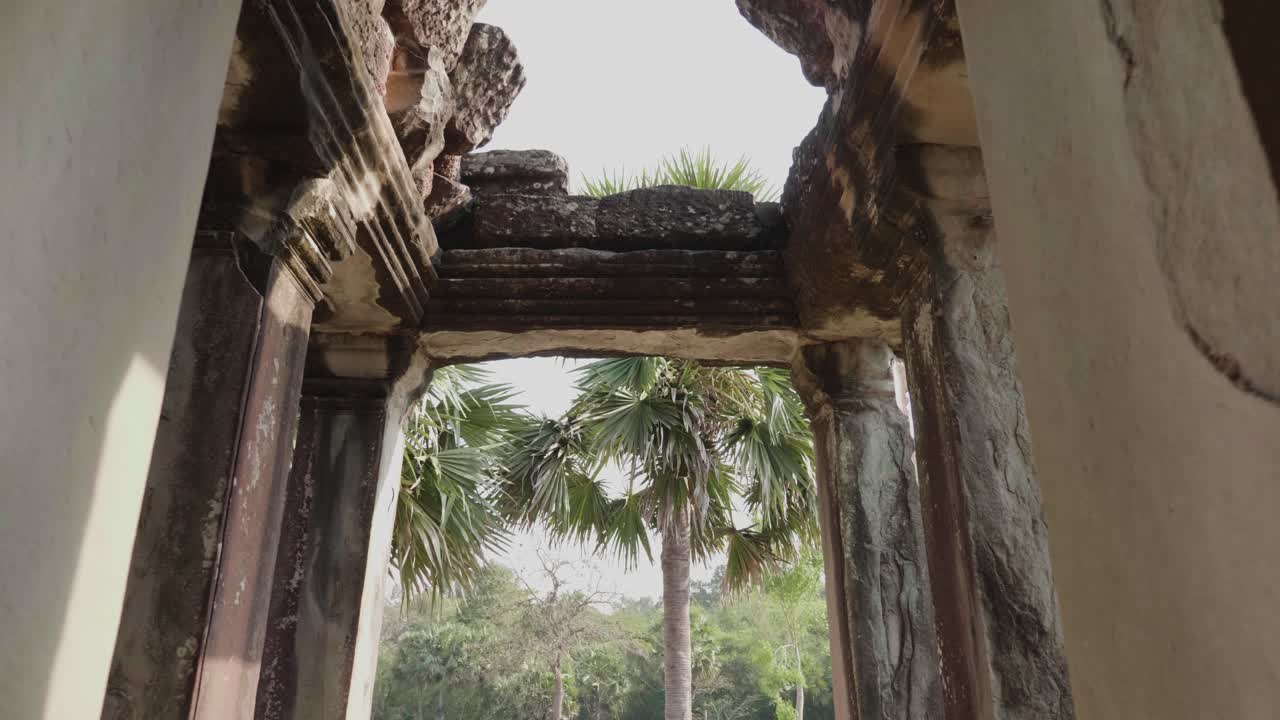Walking Through A Doorway Of A Building In The Courtyard Of Angkor Wat. 4K Slow Motion