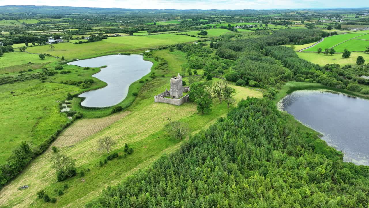 Irish Castles drone flying to Fiddaun castle Galway surrounded by lush farmlands and lakes Ireland epic Locations and Landscapes in high summer