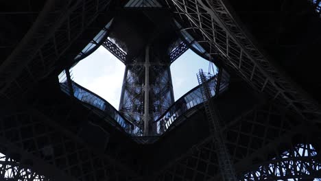 view underneath the base platform of eiffel tower during renovation in paris, france