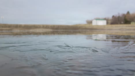 partially frozen pond on a cold cloudy day