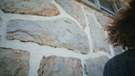 thoughtful woman looking distance standing in front wall closeup. autumn girl