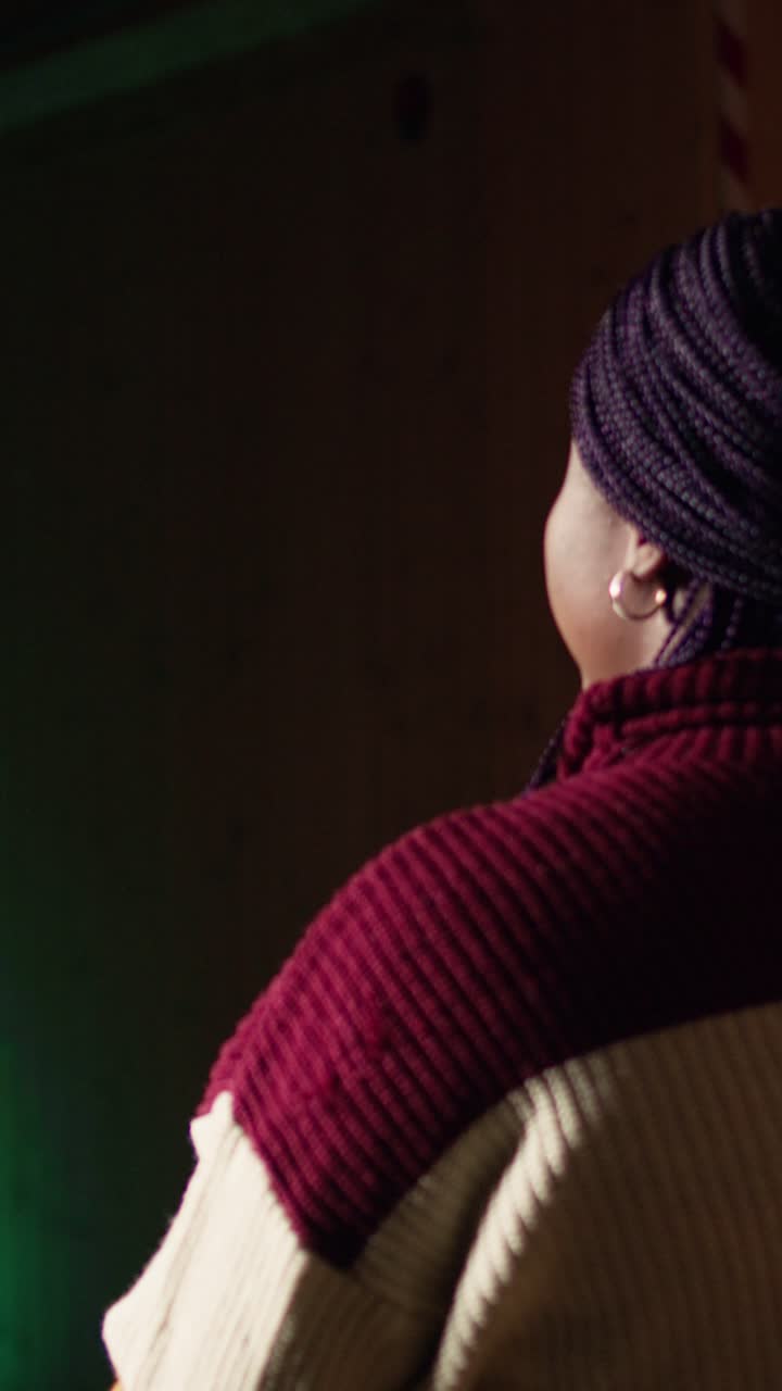 Vertical video Shooting gallery worker teaching student how to hold pistol, close up