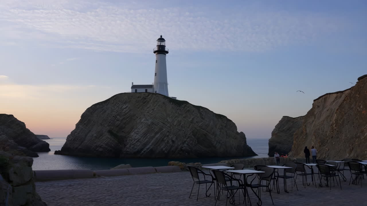 Lighthouse on a Rocky Island at Twilight with an Outdoor Cafe