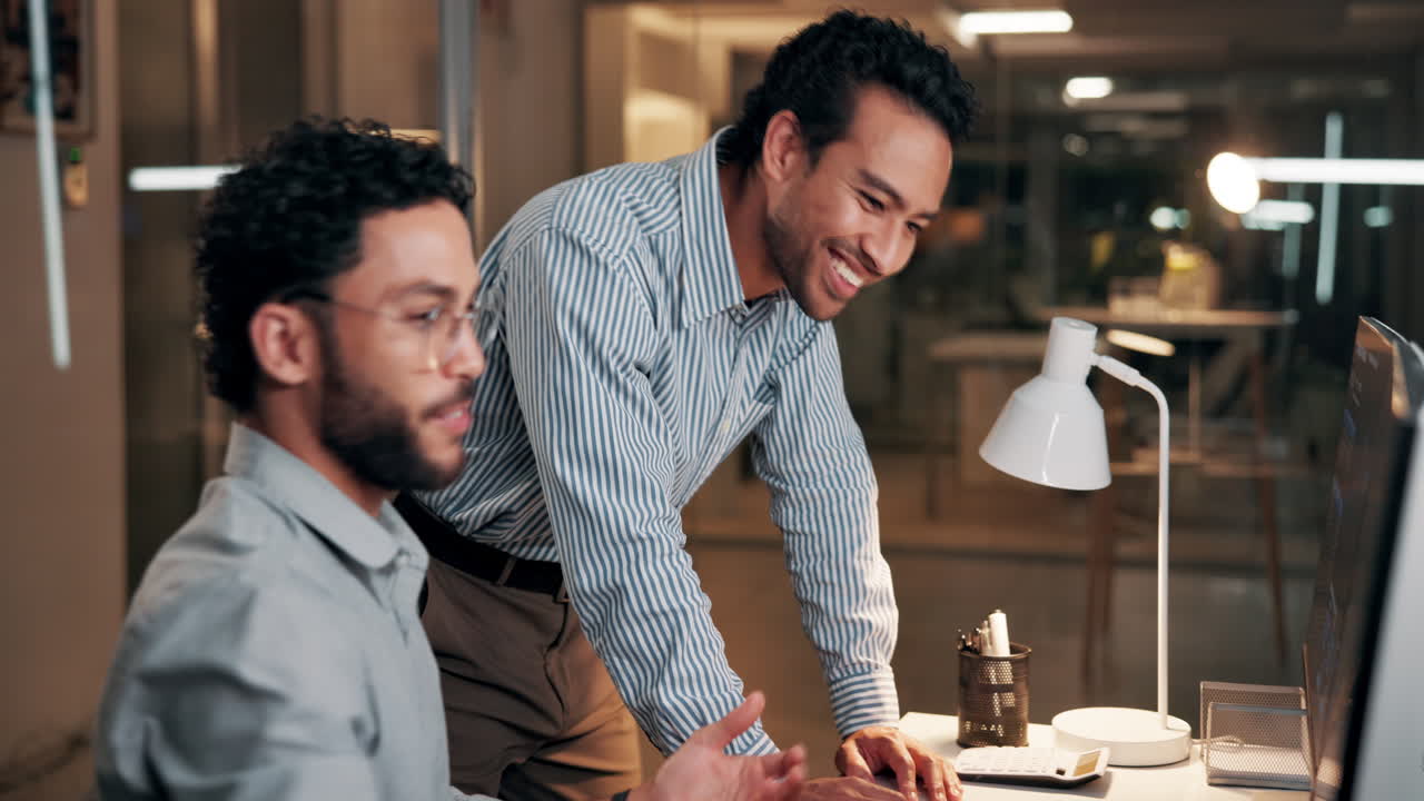 Two Male Colleagues Collaborating and Discussing Work in a Modern Office