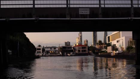 sunset over canal with modern buildings