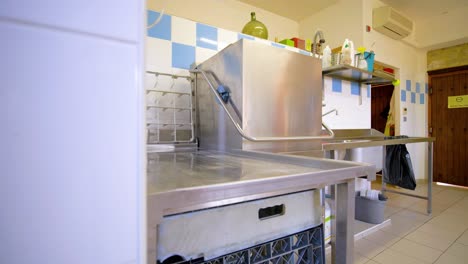 indoor restaurant kitchen with industrial dishwasher.