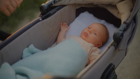 close-up of baby in stroller at sunset