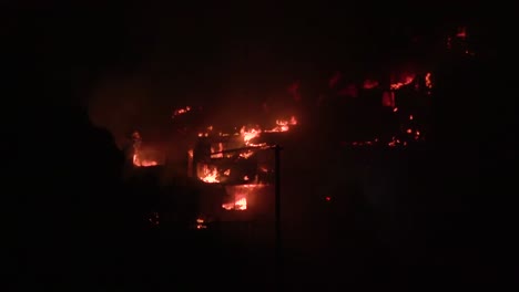 Homes-burn-at-night-during-a-large-wildfire-in-Southern-California