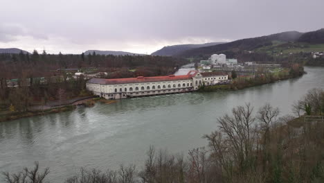 hydro power plant beznau switzerland with nuclear power reactor in the background, drone truck 4k