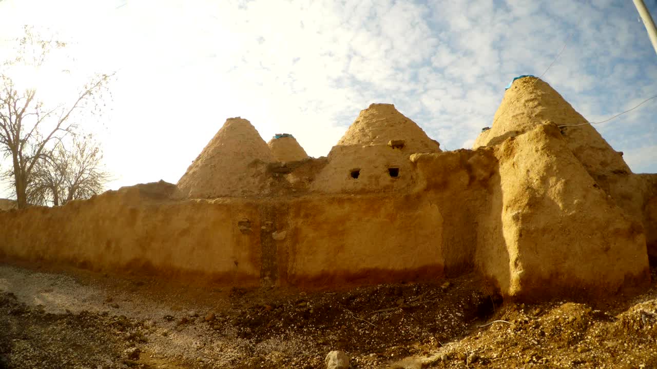 traditional clay Middle Eastern dwellings in a desert area on the border of Turkey and Syria