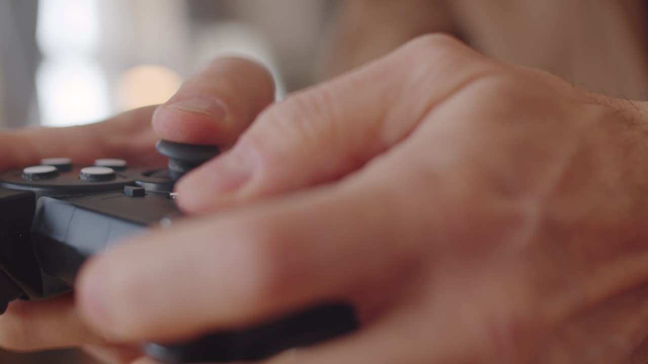 Hands of Man Using Video Game Controller