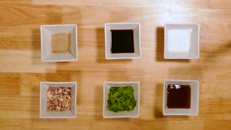 bowls of ingredient included pepper, garlic, soy sauce, salt and oyster sauce, top angle