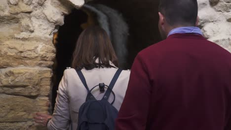 slowmotion shot of a married couple walking through an underground tunnel