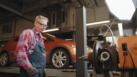 auto mechanic inspecting car brake disc