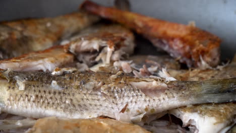 the fish is fried on one side in a pan with close up view