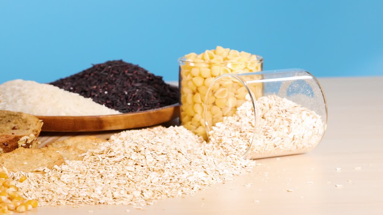 Various grains and breads displayed on a table with a bright blue backdrop, highlighting textures and colors