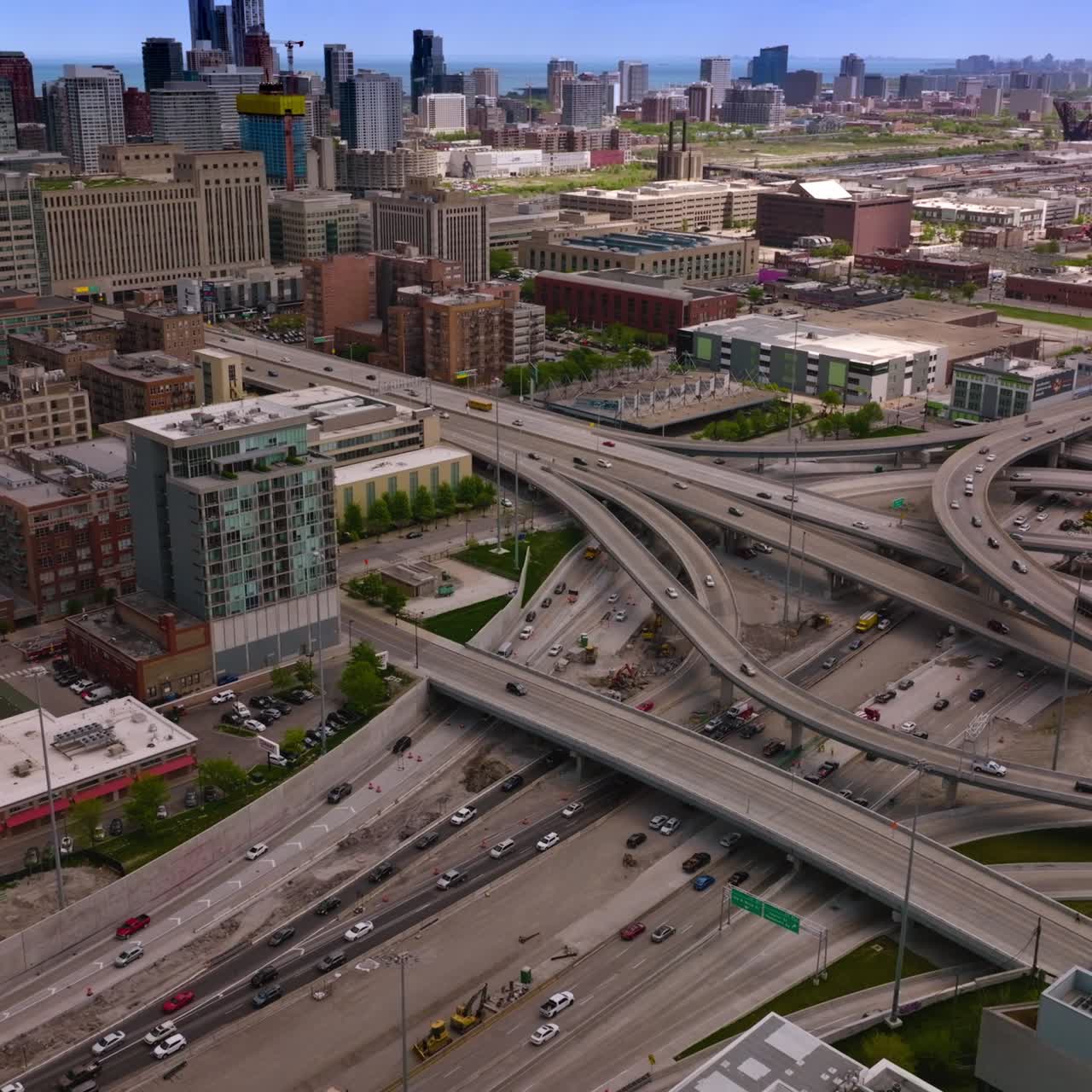 Intertwining roads of Chicago with busy traffic at daytime. Beautiful city panorama at backdrop