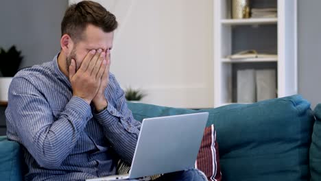 man sad for failure, working on laptop