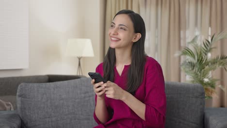 Happy-Indian-woman-chatting-with-someone