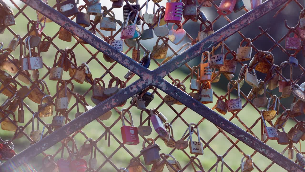 Wide view of a bunch of Love locks in a fence in Montmartre Paris during summer days.