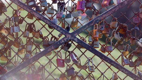 wide view of a bunch of love locks in a fence in montmartre paris during summer days.