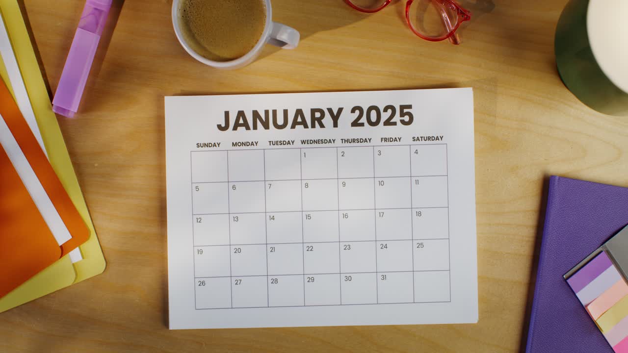 Woman reviewing January 2025 calendar at her desk