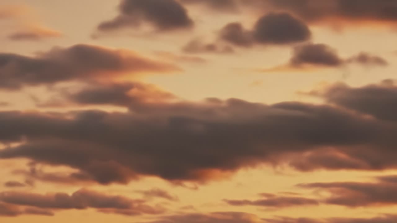 As the day ends, a stunning sunset paints the sky with hues of orange and pink while clouds drift in the gentle evening breeze. It's a peaceful moment to appreciate nature's beauty.