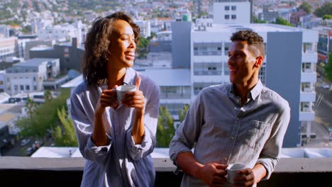 Couple-discussing-while-having-coffee-in-balcony-4k