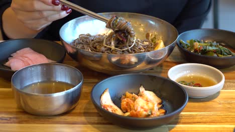 Eating-Delicious-Korean-Buckwheat-Noodles-With-A-Pair-Of-Chopsticks---close-up