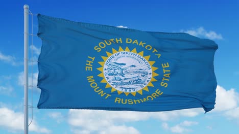 south dakota flag on a flagpole waving in the wind, blue sky background. 4k